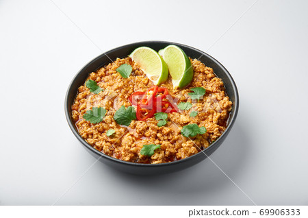 Chicken keema in black bowl isolated at white background. Chicken keema in black bowl isolated at white background. 69906333