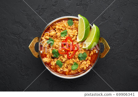 Chicken keema in traditional indian copper kadai at dark slate background. 69906341