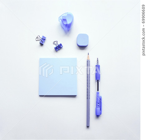 Variety of office supplies in lilac color on white desk background. Mockup for your design. Flat lay. Variety of office supplies in lilac color on white desk background. Mockup for your design. Flat lay. 69906689