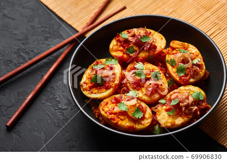 Golden Egg Curry in black bowl on dark slate background. Burmese Egg Curry is Myanmar Cuisine dish 69906830