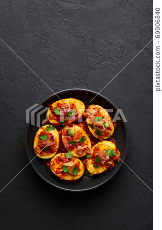Golden Egg Curry in black bowl on dark slate background. Burmese Egg Curry is Myanmar Cuisine dish 69906840