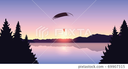 paragliding adventure by the lake at beautiful sunrise 69907315