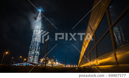 Russia, St. Petersburg, July -2020:night view of the city of St. Petersburg, view of the skyscraper business center of Gazprom, Lakhta center. the tallest building in Europe.Reflection in noise shield Russia, St. Petersburg, July -2020:night view of the city of St. Petersburg, view of the skyscraper business center of Gazprom, Lakhta center. the tallest building in Europe.Reflection in noise shield 69907577
