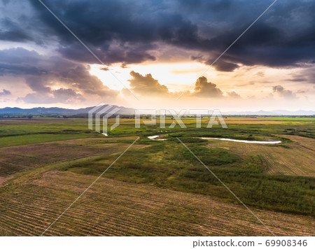 Scenic landscape aerial view of field river and basin against a natural mountain, Drone shot tropical landscape with noise and grain processed 69908346