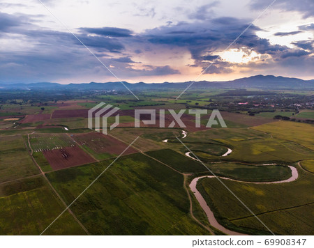 Scenic landscape aerial view of field river and basin against a natural mountain, Drone shot tropical landscape with noise and grain processed 69908347