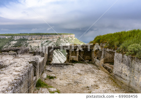 Ruins of of the ancient city-fortress Chufut-Kale built in 6th century in the Crimean Mountains Ruins of of the ancient city-fortress Chufut-Kale built in 6th century in the Crimean Mountains 69908456