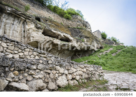 Houses built in caves in the ancient city-fortress Chufut-Kale in Crimea, Russia 69908644