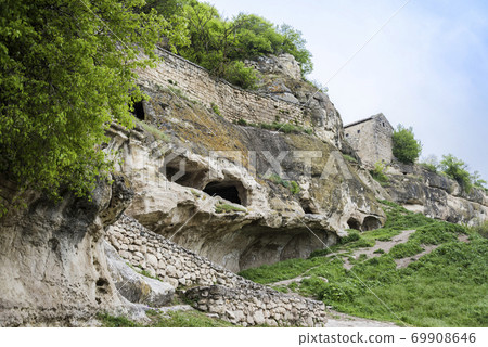 Houses built in caves in the ancient city-fortress Chufut-Kale in Crimea, Russia 69908646