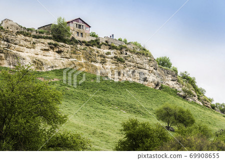 Medieval building on a high cliff in the ancient city-fortress Chufut-Kale in Crimea, Russia 69908655