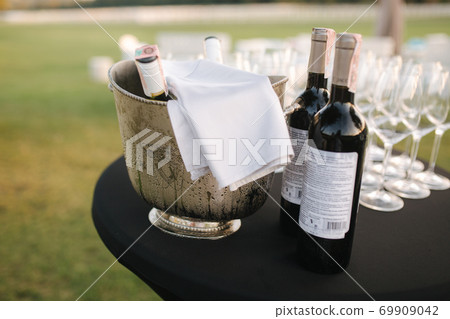 Empty Vine glasses on the table outdoors on evening coupryside party Empty Vine glasses on the table outdoors on evening coupryside party 69909042