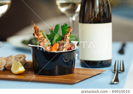 Closeup on spanish dish gambas pil-pil shrimps Closeup on spanish dish gambas pil-pil shrimps 69910010