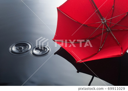 Umbrella on the rain. Umbrella inpuddle. Autumn background concept. 69911029