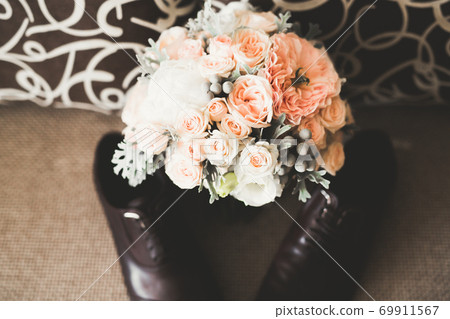 Beautiful wedding bouquet with different flowers, roses Beautiful wedding bouquet with different flowers, roses 69911567