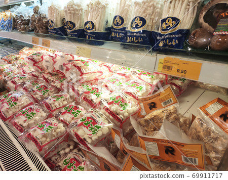 SEREMBAN, MALAYSIA -AUGUST 16, 2020: Various types of mushrooms in a transparent food package. Placed on a cooling rack and displayed to customers. SEREMBAN, MALAYSIA -AUGUST 16, 2020: Various types of mushrooms in a transparent food package. Placed on a cooling rack and displayed to customers. 69911717