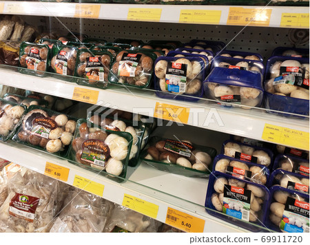 SEREMBAN, MALAYSIA -AUGUST 16, 2020: Various types of mushrooms in a transparent food package. Placed on a cooling rack and displayed to customers. SEREMBAN, MALAYSIA -AUGUST 16, 2020: Various types of mushrooms in a transparent food package. Placed on a cooling rack and displayed to customers. 69911720
