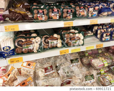 SEREMBAN, MALAYSIA -AUGUST 16, 2020: Various types of mushrooms in a transparent food package. Placed on a cooling rack and displayed to customers. SEREMBAN, MALAYSIA -AUGUST 16, 2020: Various types of mushrooms in a transparent food package. Placed on a cooling rack and displayed to customers. 69911721