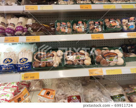 SEREMBAN, MALAYSIA -AUGUST 16, 2020: Various types of mushrooms in a transparent food package. Placed on a cooling rack and displayed to customers. 69911724