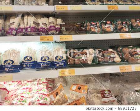 SEREMBAN, MALAYSIA -AUGUST 16, 2020: Various types of mushrooms in a transparent food package. Placed on a cooling rack and displayed to customers. 69911725