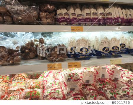 SEREMBAN, MALAYSIA -AUGUST 16, 2020: Various types of mushrooms in a transparent food package. Placed on a cooling rack and displayed to customers. 69911726