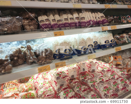 SEREMBAN, MALAYSIA -AUGUST 16, 2020: Various types of mushrooms in a transparent food package. Placed on a cooling rack and displayed to customers. 69911730