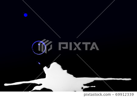 spilled colored gradient blue and white milk on a black wooden background. Place for text spilled colored gradient blue and white milk on a black wooden background. Place for text 69912339