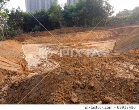 CYBERJAYA, MALAYSIA -JANUARY 6, 2020: Earthworks for new development. Heavy machinery performs forest clearing and earthworks to obtain the required level. 69912486