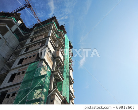KUALA LUMPUR, MALAYSIA -APRIL 3, 2020:The construction site is operating during the day. Workers are busy carrying out their activities as planned under the supervisor's supervision. KUALA LUMPUR, MALAYSIA -APRIL 3, 2020:The construction site is operating during the day. Workers are busy carrying out their activities as planned under the supervisor's supervision. 69912605