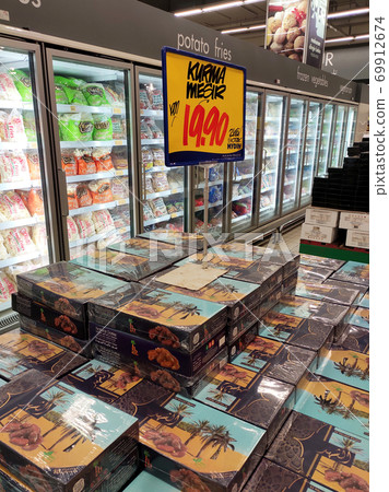 SEREMBAN, MALAYSIA -JULY 14, 2020: Dates are sold in boxes and sorted by brand and price tagged. Dates are a nutritious fruit originally from the middle east. 69912674