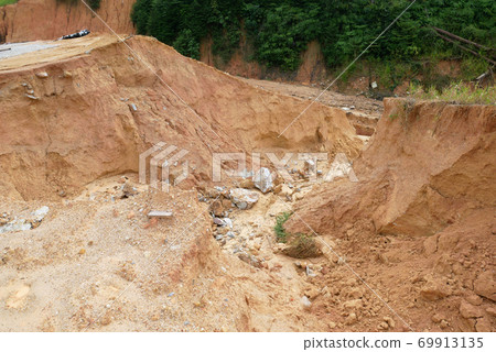 Erosion at ground and slopes is caused by rainfall. The soil structure is weak and there is a landslide. Safety measure has been taken in some area. Erosion at ground and slopes is caused by rainfall. The soil structure is weak and there is a landslide. Safety measure has been taken in some area. 69913135