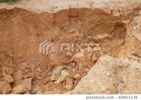 Erosion at ground and slopes is caused by rainfall. The soil structure is weak and there is a landslide. Safety measure has been taken in some area. 69913136