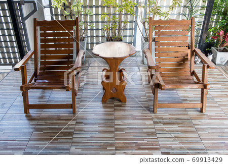 Twin reclining wooden chair on the terrace. Twin reclining wooden chair on the terrace. 69913429