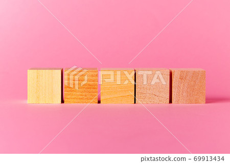 Toy wooden cubes with copy space against pink background Toy wooden cubes with copy space against pink background 69913434