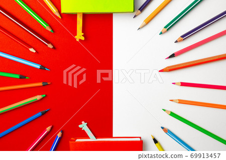Colorful pencils and notepads on paper background top view Colorful pencils and notepads on paper background top view 69913457