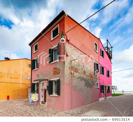 Facades of traditional old houses on the island of Burano. 69913814