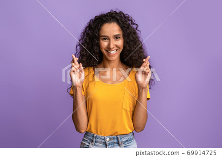 Cherished Wish. Positive Brunette Woman Crossing Fingers And Smiling, Begging For Luck 69914725