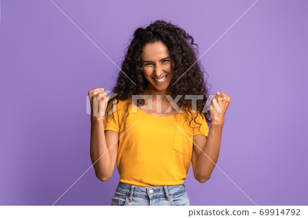 Joy Of Success. Euphoric Young Brunette Woman Celebrating Victory With Clenched Fists 69914792