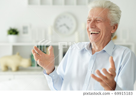 Portrait of happy senior man at home 69915183