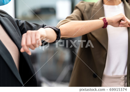 businesswomen wear face mask elbow greeting in new normal office lifestyle 69915374