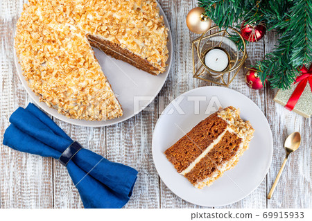 Piece of Carrot cake with cream cheese frosting and walnuts, Christmas decoration on a  background, horizontal, top view 69915933