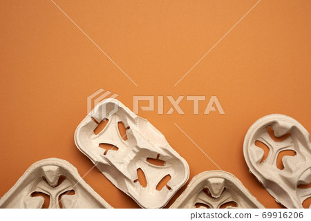 paper tray for drinks in takeaway cups on four cups on a brown background paper tray for drinks in takeaway cups on four cups on a brown background 69916206