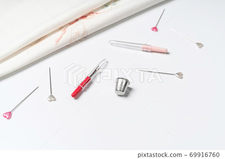 White canvas background with sewing tools and colorful threads. Mockup for hobby. Embroidery concept. 69916760