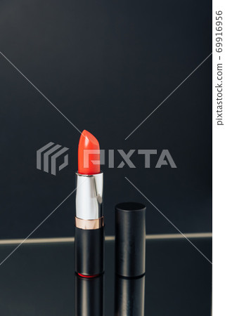Lipstick in different colors on a dark background 69916956