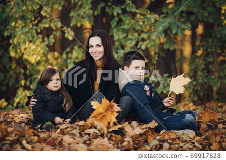 Caucasian family goes for a walk in the autumn 69917828