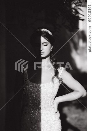 Black and white photo of gorgeous model. Hulf of face in shadow 69918361