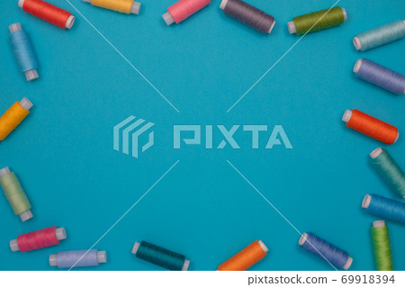 Multicolored cotton threads, spools, handmade sewing. Top view with copyspace, flat lay. Multicolored cotton threads, spools, handmade sewing. Top view with copyspace, flat lay. 69918394