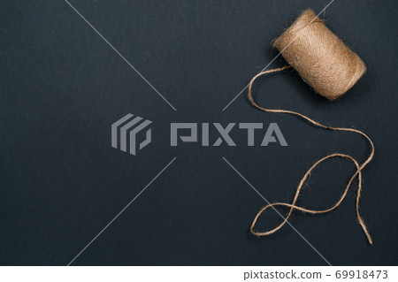 Hemp twine. Natural materials for crafts. Top view with copy space, flat lay. Hemp twine. Natural materials for crafts. Top view with copy space, flat lay. 69918473