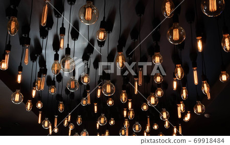 Retro Edison lamp on a black background of the ceiling. Concept idea 69918484