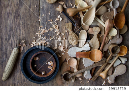 Handmade wooden kitchen utensils, top view lot of billets, spoons and plates on wooden table, selective focus 69918739