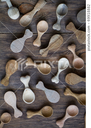 Handmade wooden utensils, top view lot of billets and spoons on wooden table, selective focus 69918882