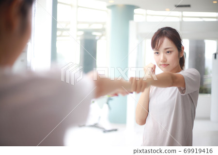 Woman doing shadow boxing Woman doing shadow boxing 69919416